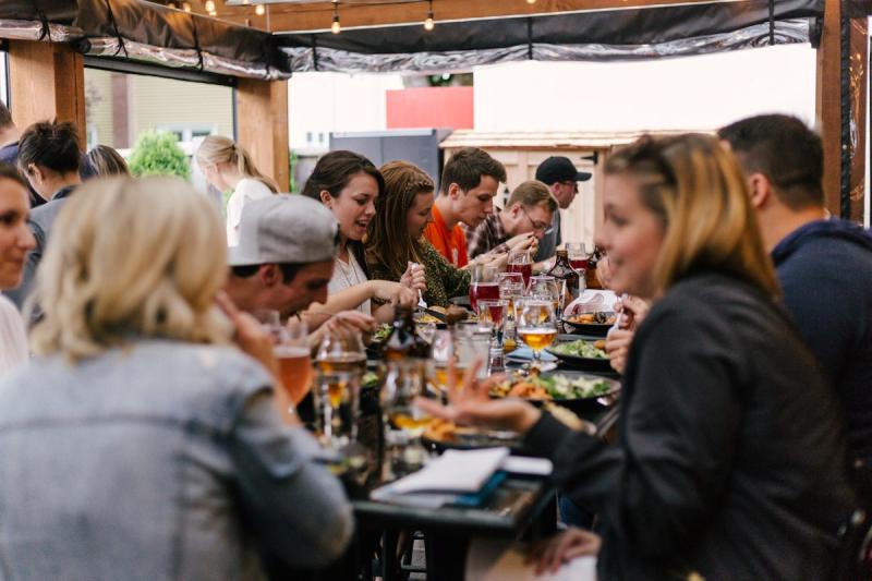 A group of independent workers gathered around a table,
talking and sharing ideas