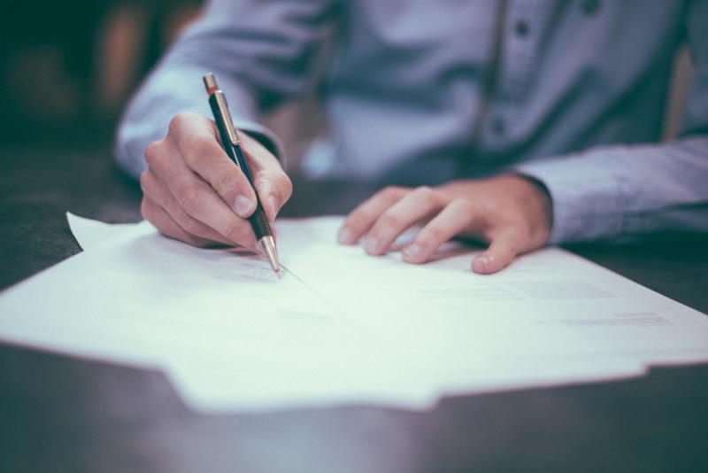 Professional reviewing financial documents at a well-organized desk