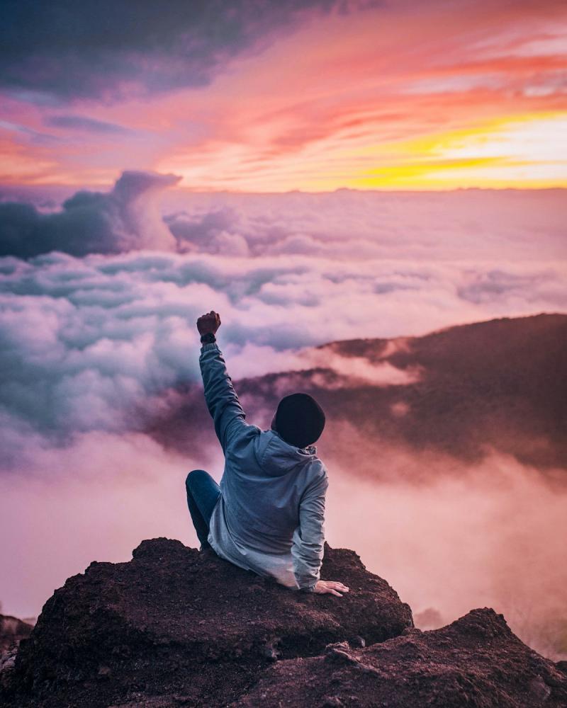 Person embracing freedom and new beginnings in an open landscape