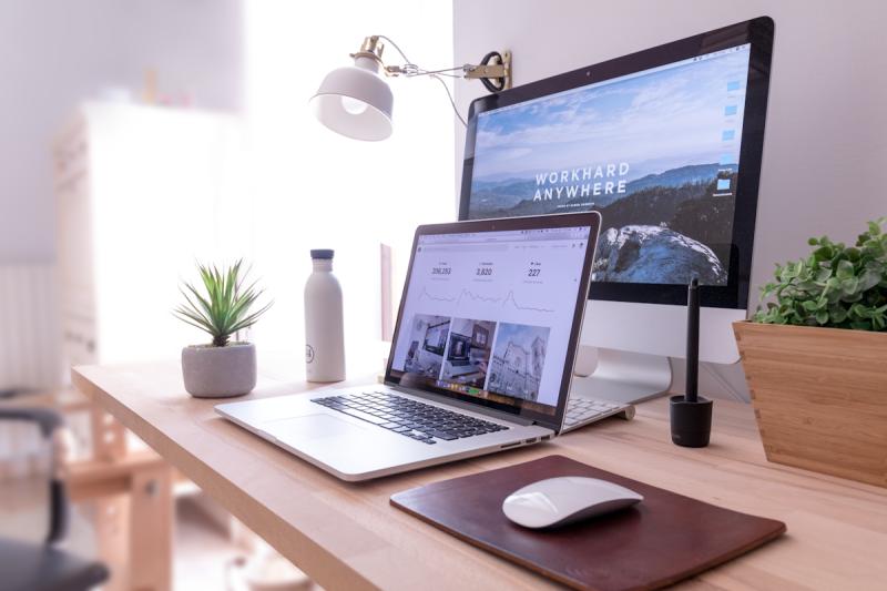 Solo worker at a home desk gazing out the window during a quiet afternoon